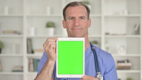 Doctor Holding Tablet with Green Screen in Office