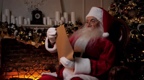 Santa Reading Christmas List by Fireplace