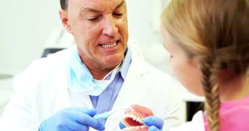 Dentist Explains Braces and Brushing to Child