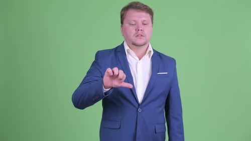 Sad Overweight Bearded Businessman Giving Thumbs Down