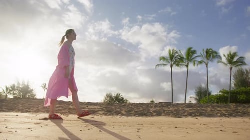 Slow Motion Low Angle RED Camera Shot of Young Woman on Beach Morning Walk