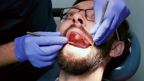 Man Receiving Dental Exam at Dentist Office