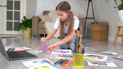 Girl Paints in Living Room Art Studio
