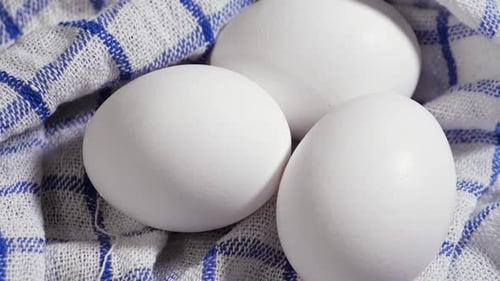 Close Up of Three White Eggs on Towel