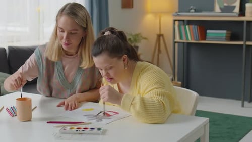 Two Friends Painting Together at a Table