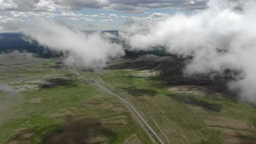 Aerial View of Grassy Landscape with Clouds