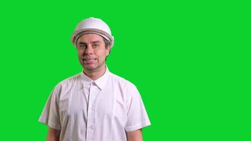 Young Male Engineer Standing and Smiling on Green Screen Background