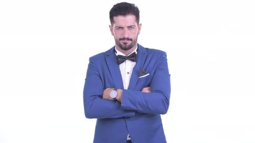 Smiling Man in Blue Suit and Bowtie Poses