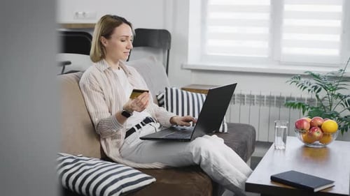 A Young Attractive Woman Pays for Purchases on the Internet Using a Credit Card