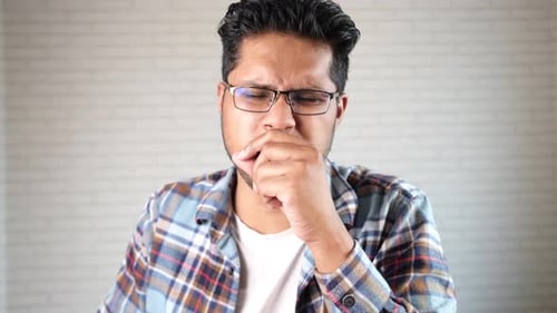 Young Sick Man Coughing and Sneezes