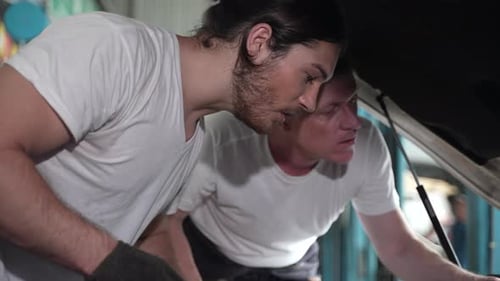 Mechanics Working on a Car Engine