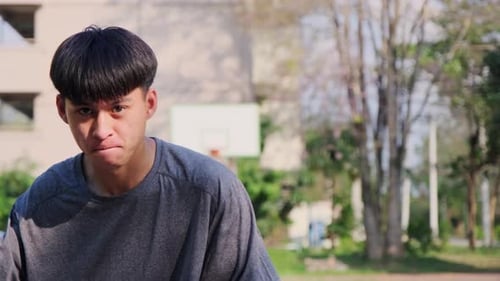 Young Adult Dribbling Basketball on Urban Court