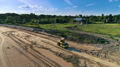 Aerial view of roller that compacts high spots down until soil is smooth