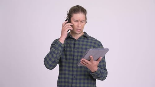 Young Adult Using Tablet and Talking on Phone