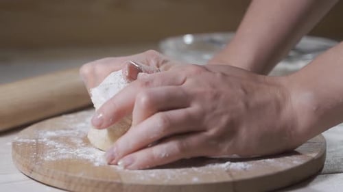 Baker Kneading Dough Covered in Flour, Close Up