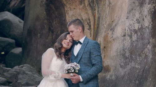 Newlywed Wedding Couple Walking in the Park. Two Young People in Love Meet Each Other's Eyes