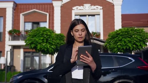 Woman Using Tablet Outside Office Building