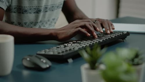 Close Up of Hands Using Computer Keyboard and Listening to Music