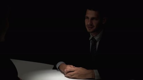 Business Deal Handshake in Dark Office