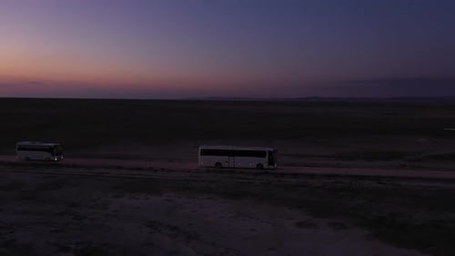 Sunset And Traveling Buses Aerial View