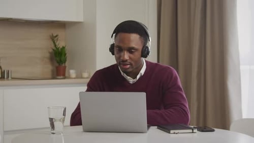 Young Adult Working On Laptop At Home