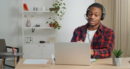 Man Video Conferencing on Laptop in Home Office