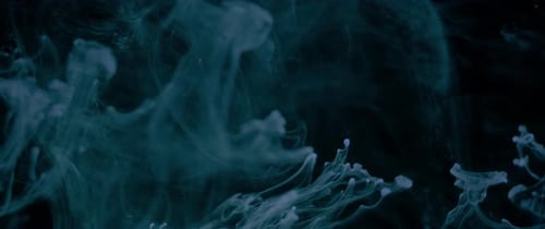 Abstract Teal Ink Swirling in Deep Black Water