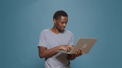Cheerful Person Browsing Internet on Laptop Computer