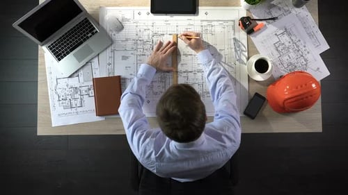Engineer Preparing Building Drawing for Tender, Making Corrections, Top View