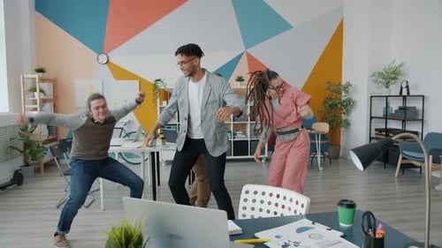 Cheerful Young People Coworkers Dancing at Office Business Party Having Fun Together