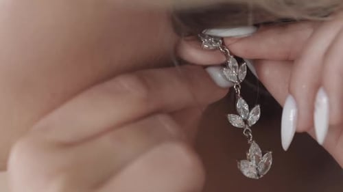 Woman Attaching Leaf Shaped Wedding Earring