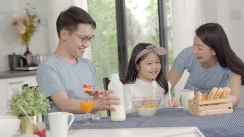 Happy Family Enjoying Breakfast Together at Home