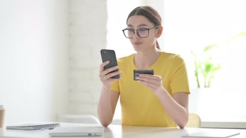 Woman Shopping Online with Phone and Credit Card