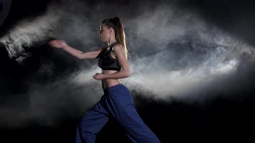 Athletic Woman Practicing Martial Arts Punches and Blocks