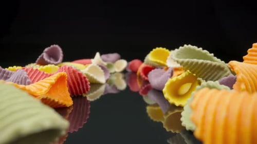 Colorful Conchiglie Pasta on Reflective Surface