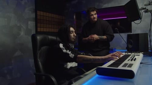 Cool Black Hip Hop Artist and Stylish Sound Producer Creating New Track in Music Recording Studio