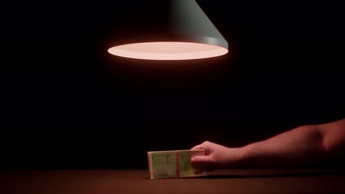 Money Exchanged in Dark, Suspenseful Scene