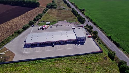 Trucks in the Parking Lot Near Warehouse