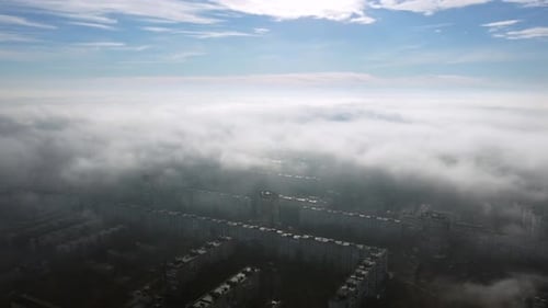 Aerial Drone View Flight Over Above Fog Mist and Roofs of Buildings in City