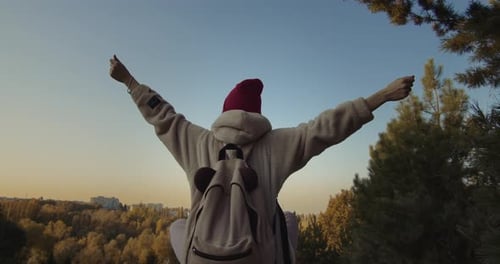 Young Person Celebrates Autumn in Urban Park
