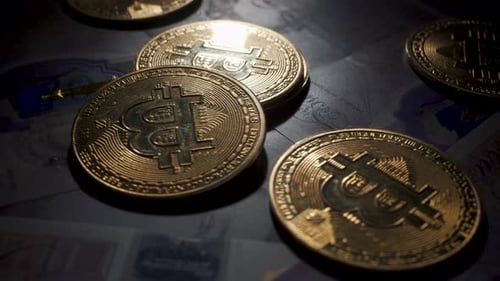 Bitcoin BTC coin rotating on bills of 20 pounds. Smoke is let on coins Digital coin cyberspace and c