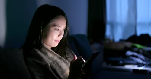 Asian woman use of tablet computer at home in the evening