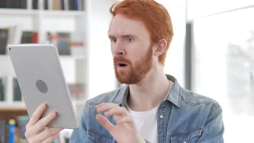 Casual Redhead Man Reacting to Loss While Using Tablet