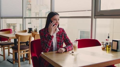 Woman Speaking on Phone in Urban Restaurant