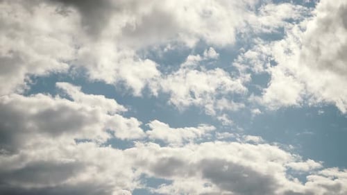 Fluffy White Clouds Drifting across Blue Sky Time-lapse