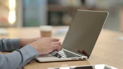 Close Up of African Woman Typing on Laptop