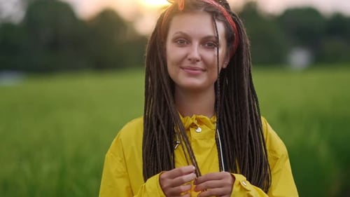 Close Up Portrait of Young Woman Smiling in Wind Looking at Sunset Over Forest