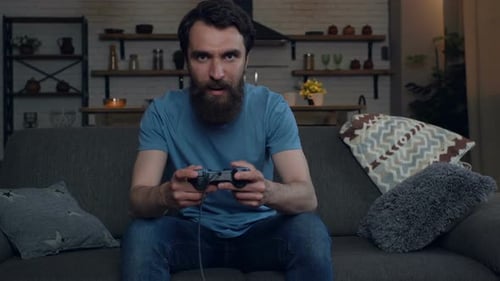 Bearded Man Playing Video Games on Couch