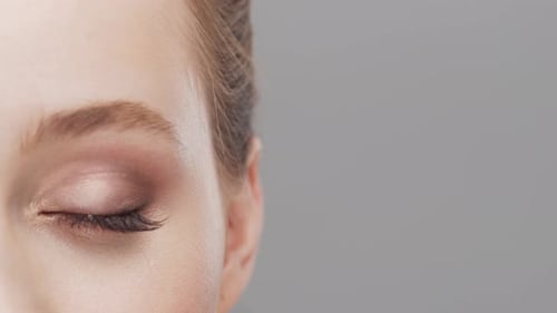 Studio portrait of young, beautiful and natural woman over grey background.