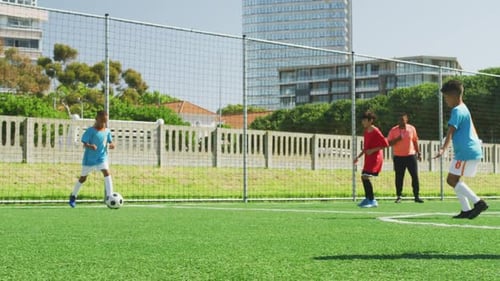 Soccer kids playing in a sunny day
